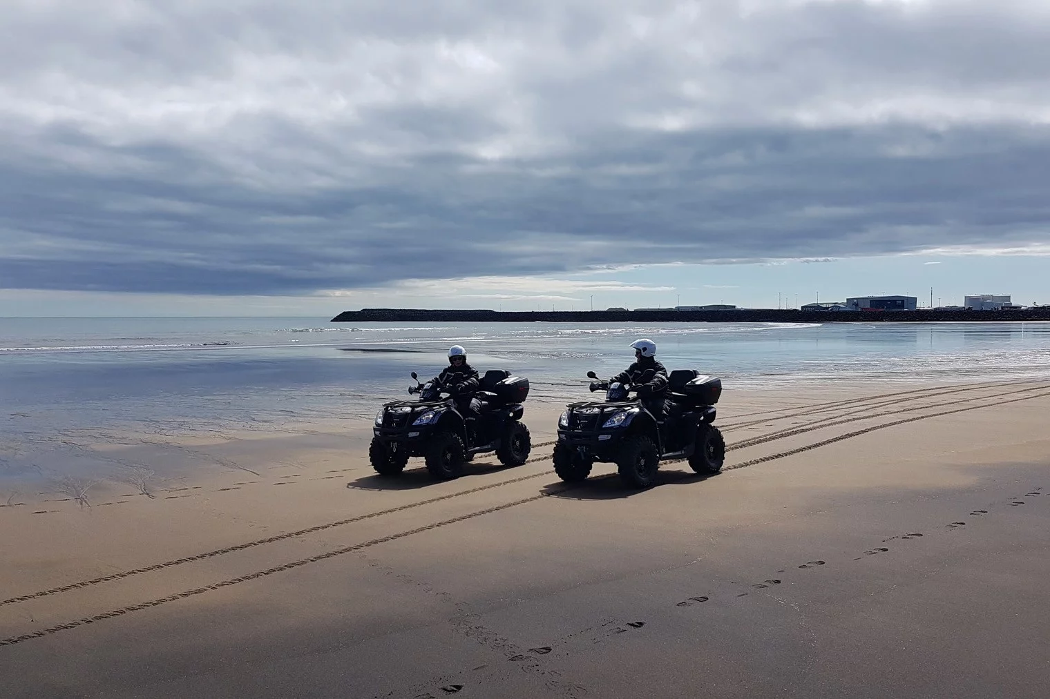 Two buggies driving on the beach